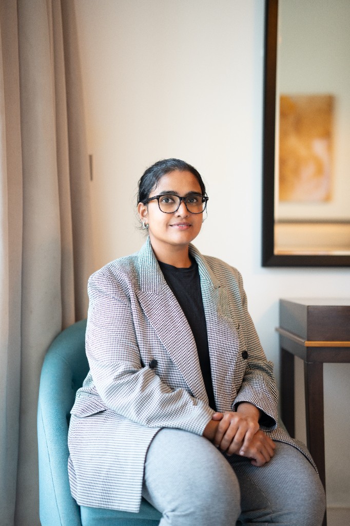 Portrait of Sumana Beena Shivaprakash, seated, facing the camera.
